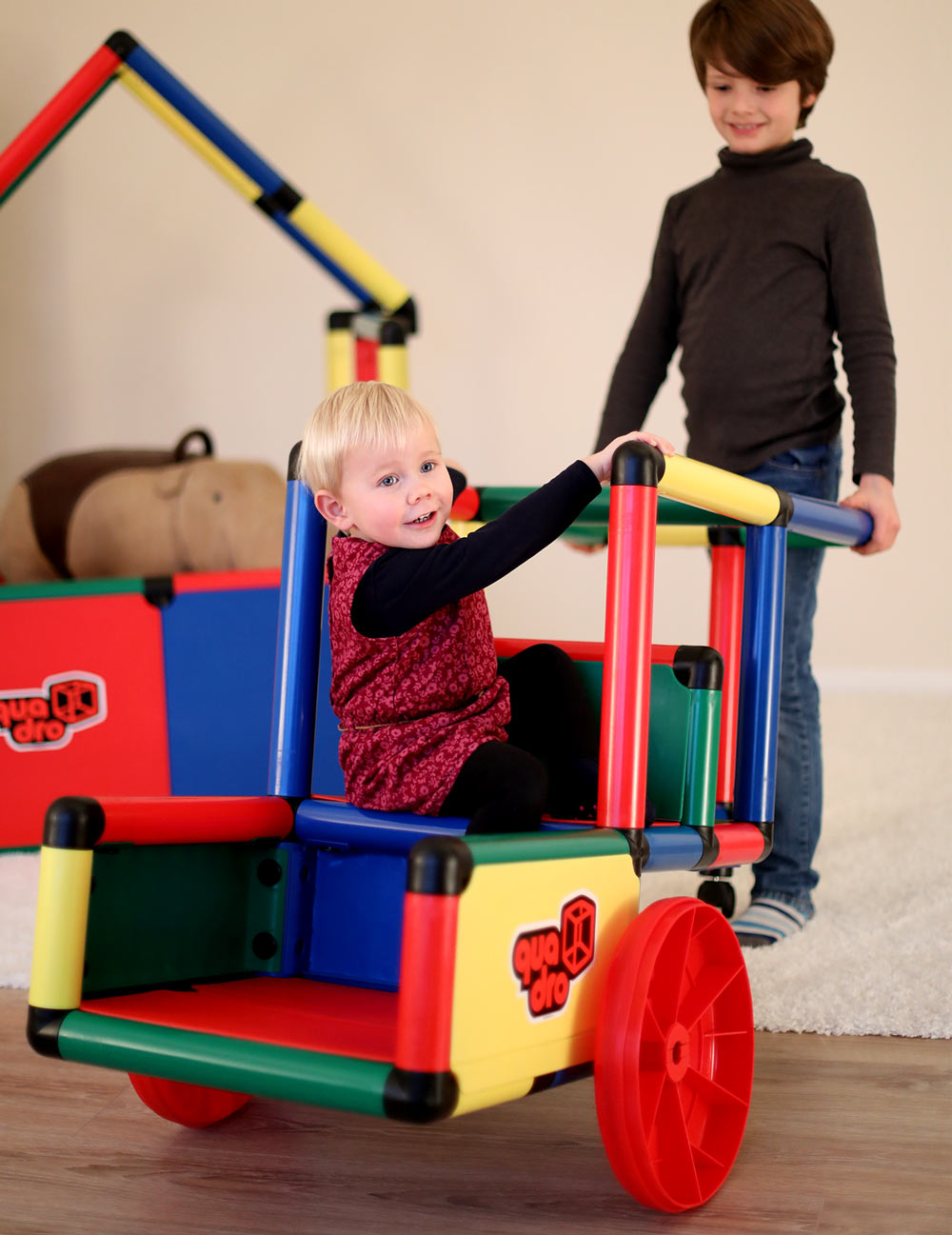 quadro-child-development-young-buy-pushing-toddler-in-cart.jpg