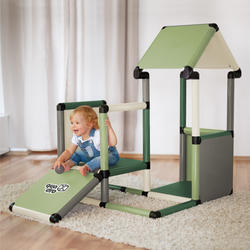 Child sitting on a playhouse ramp