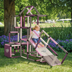 Girl sliding down ramp from climbing frame