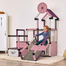 Child sliding on play house climbing frame