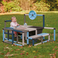 Child playing with sand on a play table