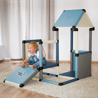 Child sitting on a playhouse ramp