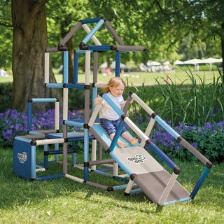 Girl sliding down ramp from climbing frame