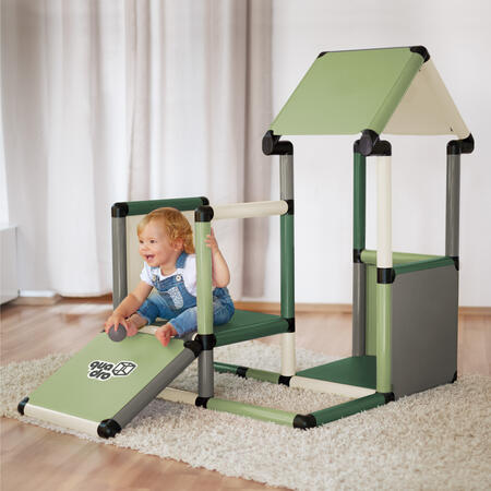 Child sitting on a playhouse ramp