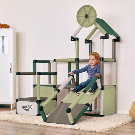 Child sliding on play house climbing frame